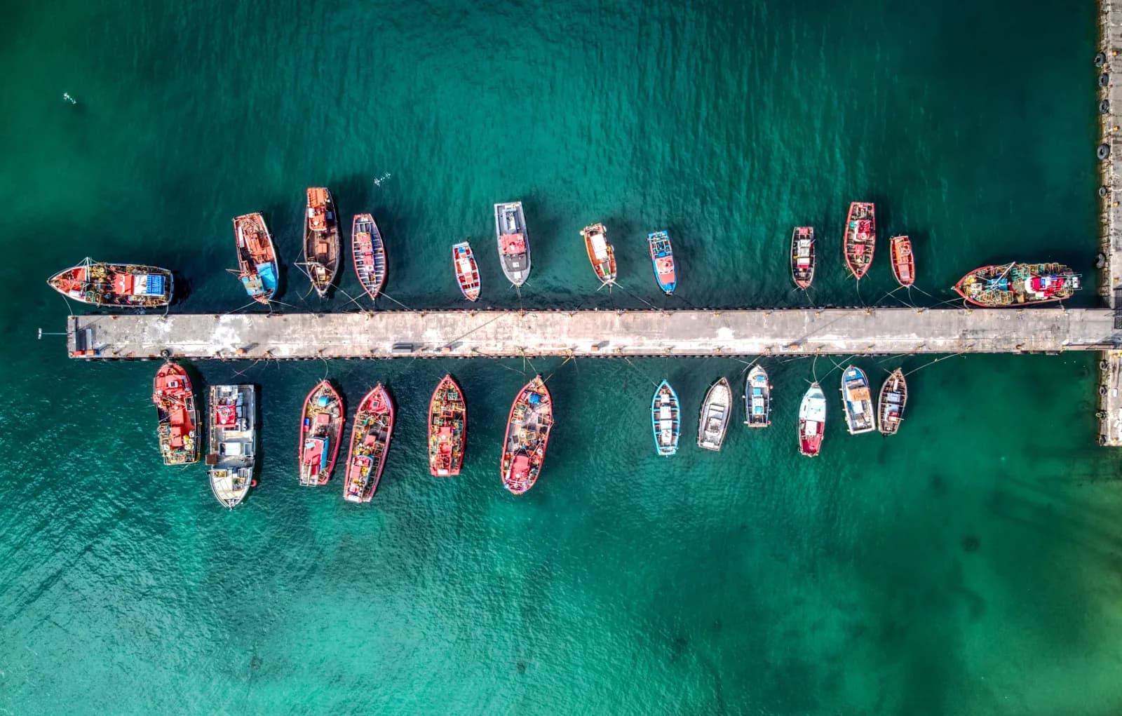 Ao Por pier with fishing boats along the dock, aerial view