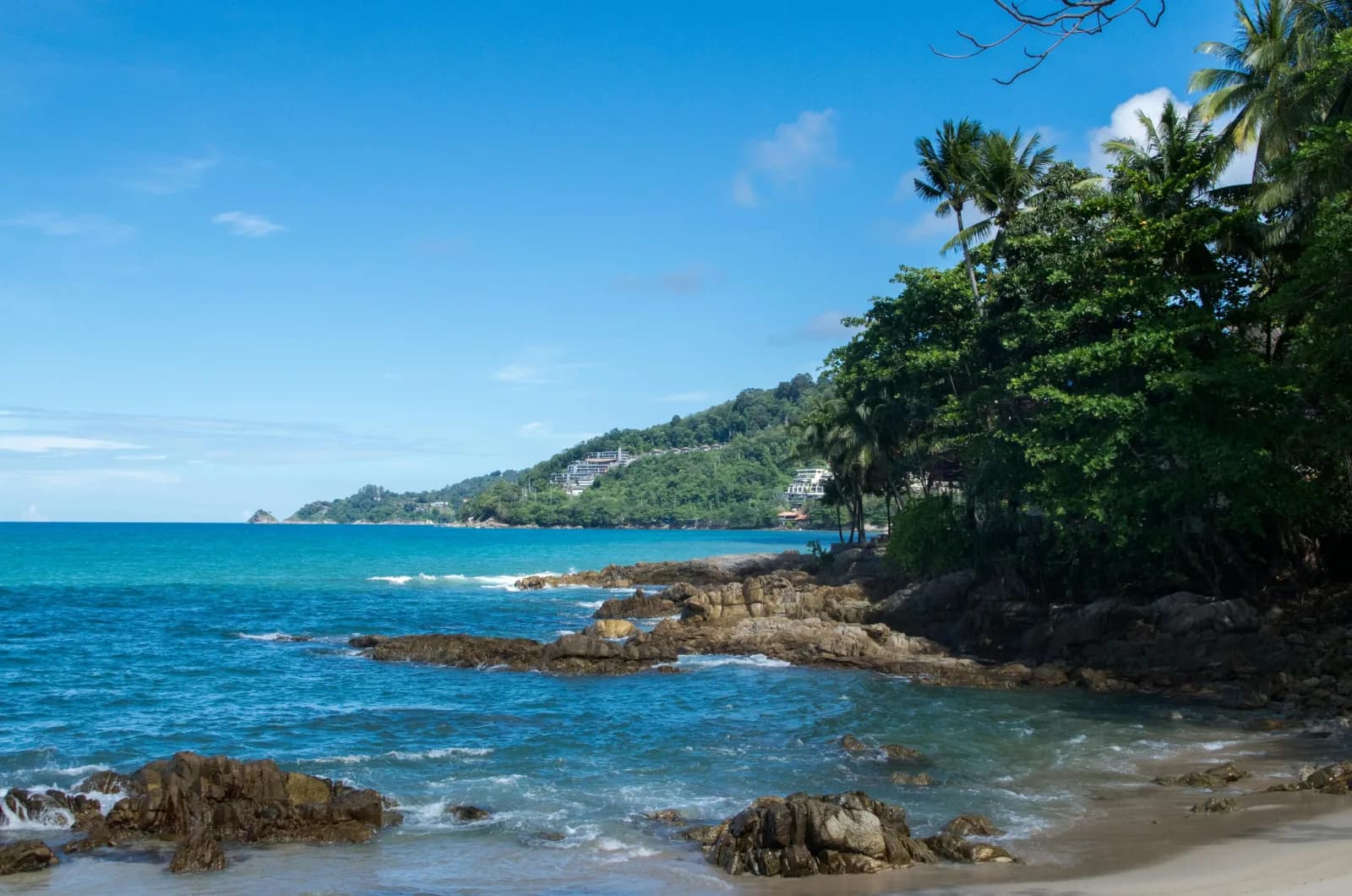 Rocky shore and turquoise sea at Karon Beach