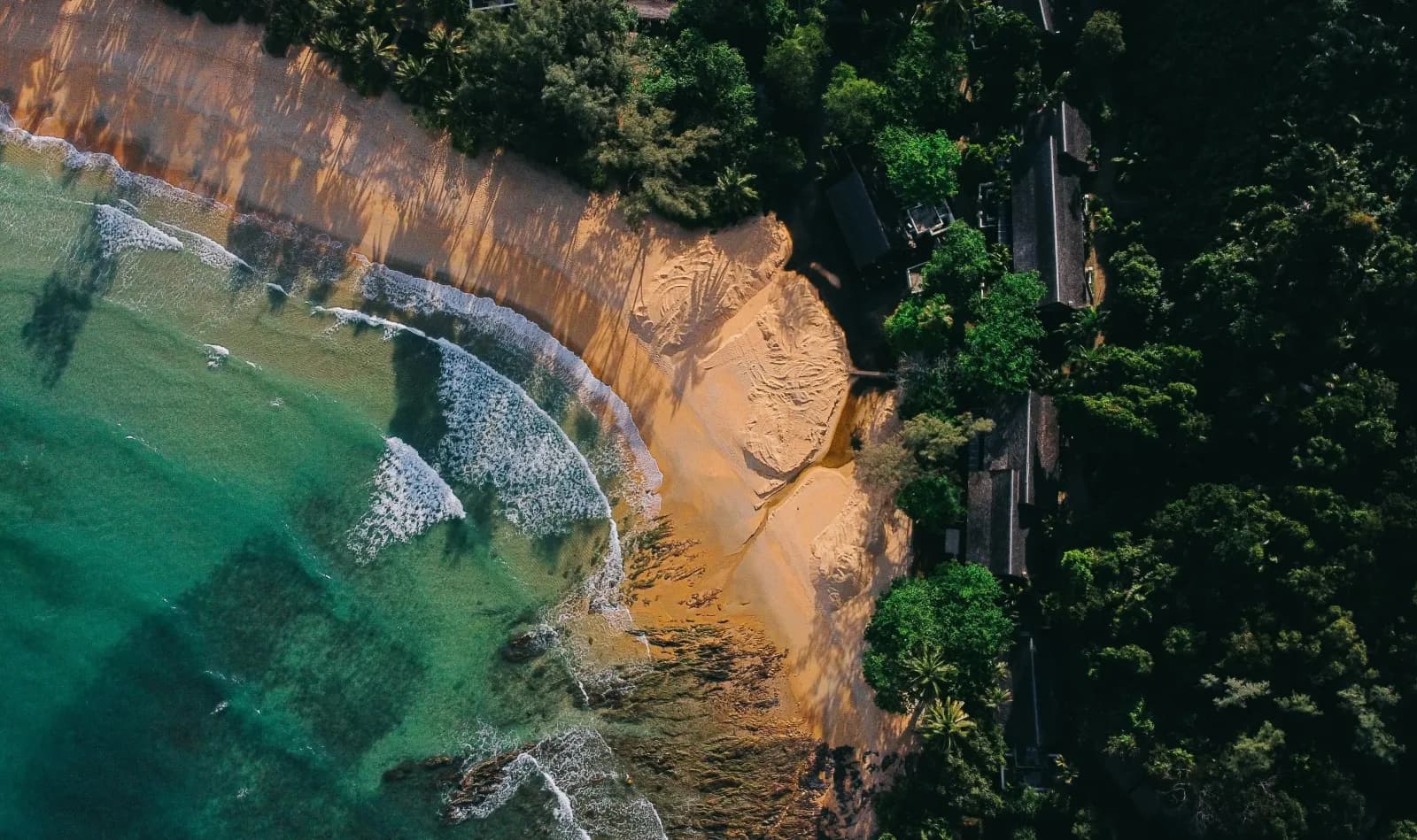 Aerial view of the curved Surin Beach coastline